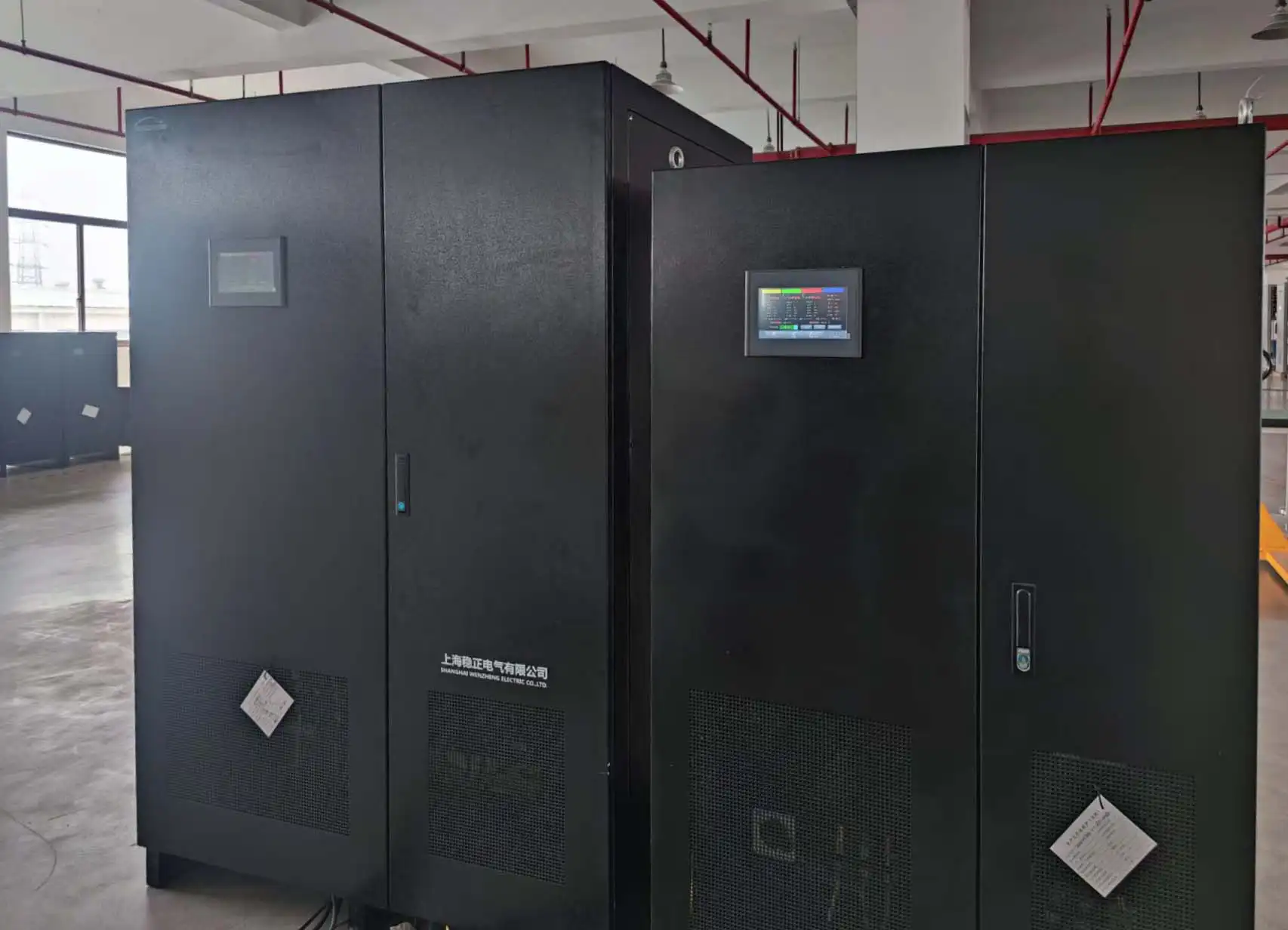 Factory test setup with the grid simulator on the left and the 200kVA IGBT static automatic voltage stabilizer on the right.