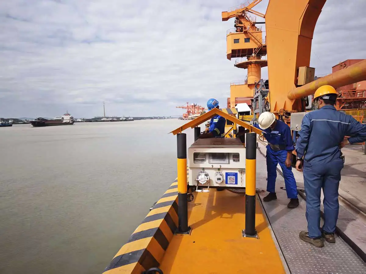 Engineers commissioning a berth-side shore power cabinet at the Baosteel Meishan raw-material terminal