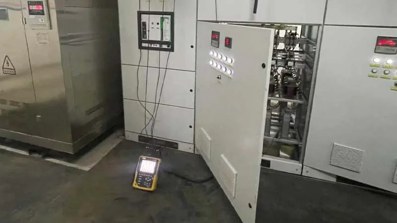 Power-quality analyzer connected to distribution equipment during commissioning verification